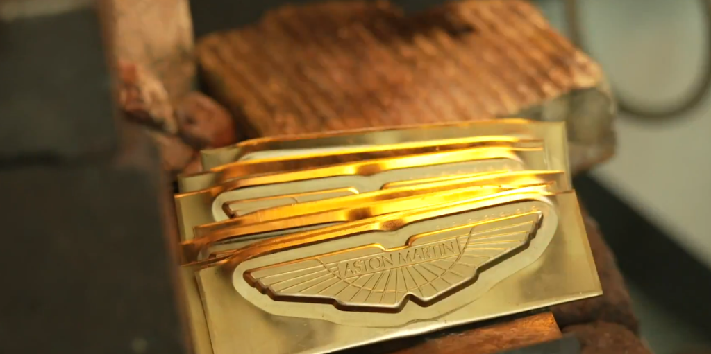 Aston Martin Wings Badge Lawsuit Targets a Company That Actually Owns Part of Aston Martin — Yes, Really